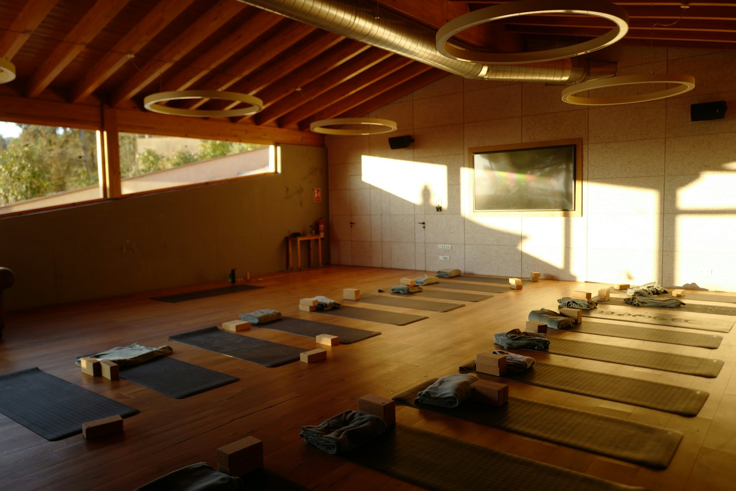 Modern yoga studio interior set up for class with mats and props.